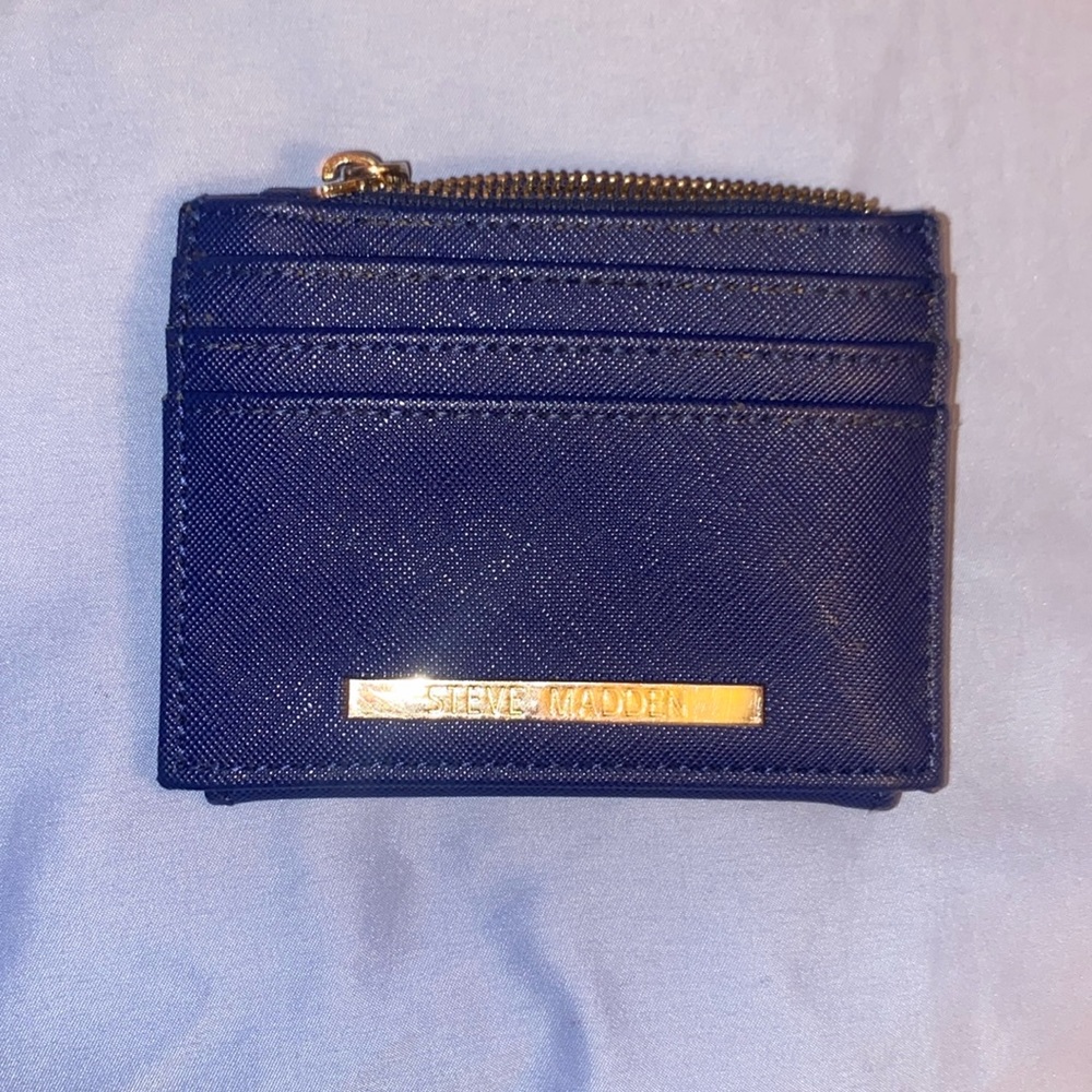 A royal gray-blue color. Real Steve Madden wallet. 2 inches tall 3 inches wide.